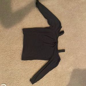 It is a black long sleeved shirt with shoulders out